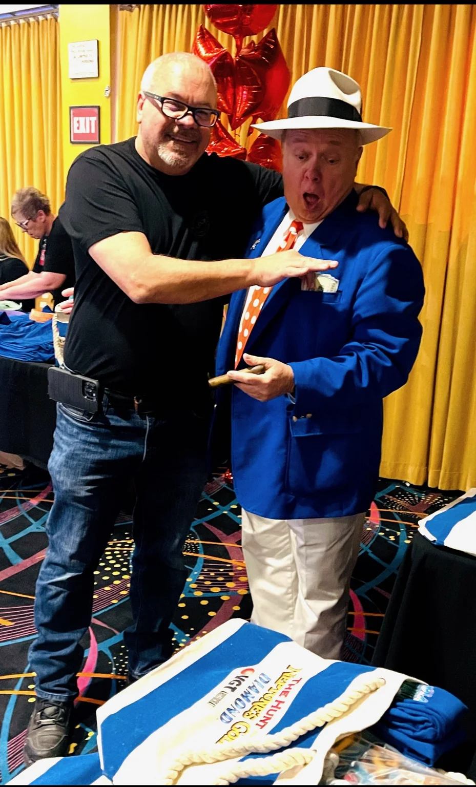 Mike and Karl smiling beside a cake at a celebration